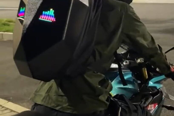 Motorcycle Backpack -  Knight Big featuring a LED motorcycle backpack worn by a rider on a bike at night.