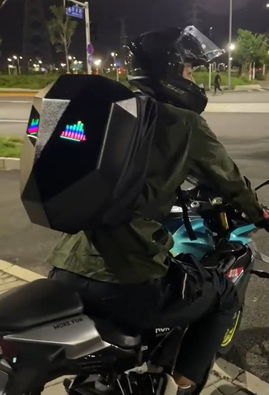 Motorcycle Backpack -  Knight Big featuring a LED motorcycle backpack worn by a rider on a bike at night.