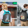 Two models, a man and a woman, wearing Gelrova City Series pixel backpacks in a city street setting. The backpacks display unique custom pixel art: a cool yellow duck with sunglasses and a futuristic blue dog.