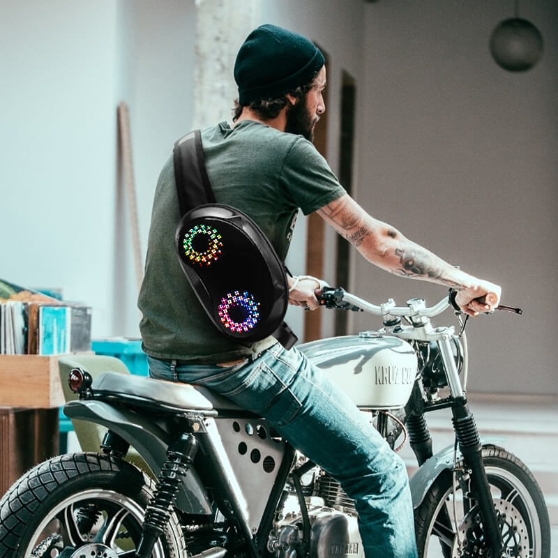 Man wearing Gelrova LED Crossbody Bag with colorful patterns on a motorcycle, showcasing stylish tech and everyday utility.