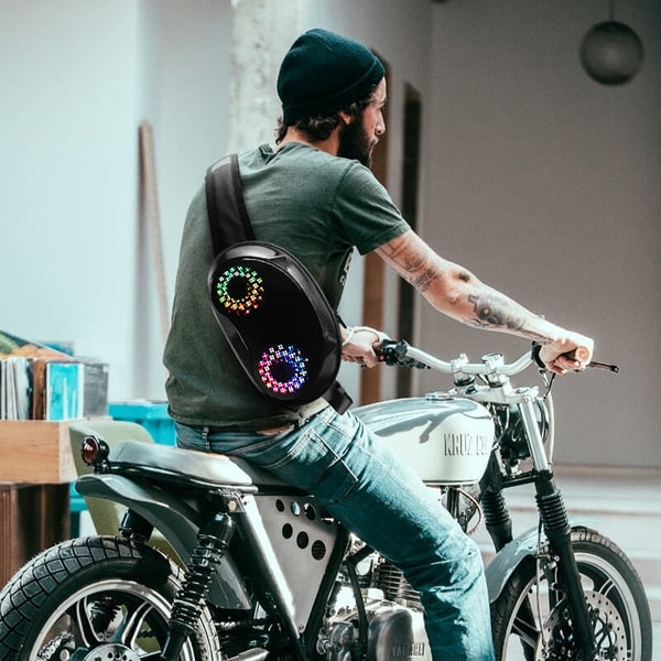 Man wearing Gelrova LED Crossbody Bag with colorful patterns on a motorcycle, showcasing stylish tech and everyday utility.