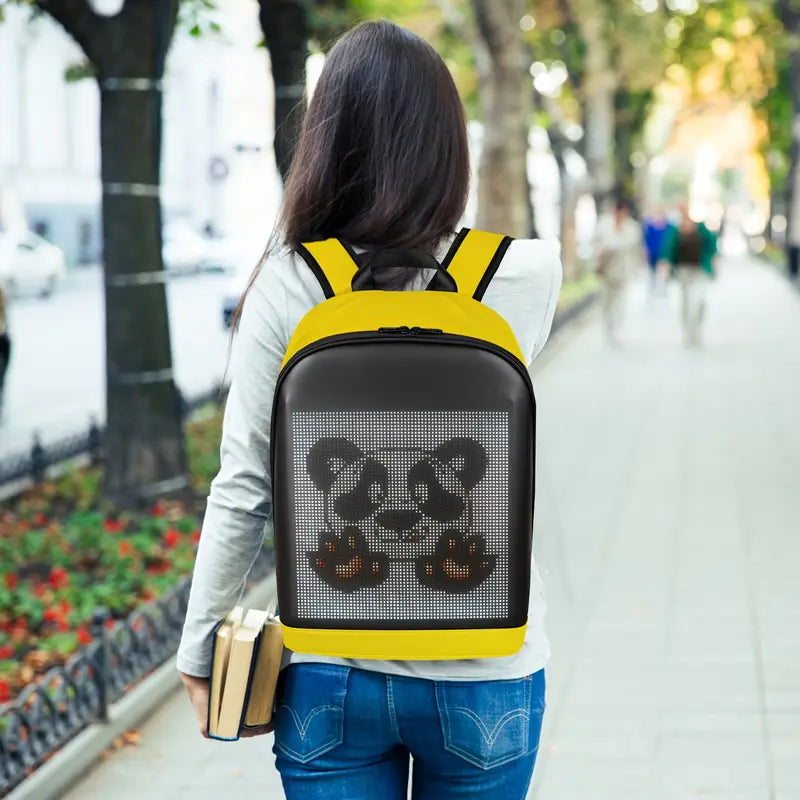 Gelrova T2 LED Backpack – 16.5" in yellow displaying a panda design on its LED screen while being carried outdoors.