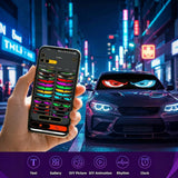 A hand holding a smartphone app to customize the Gelrova Demon Eyes 2 Pack car window LED display on a sports car windshield.