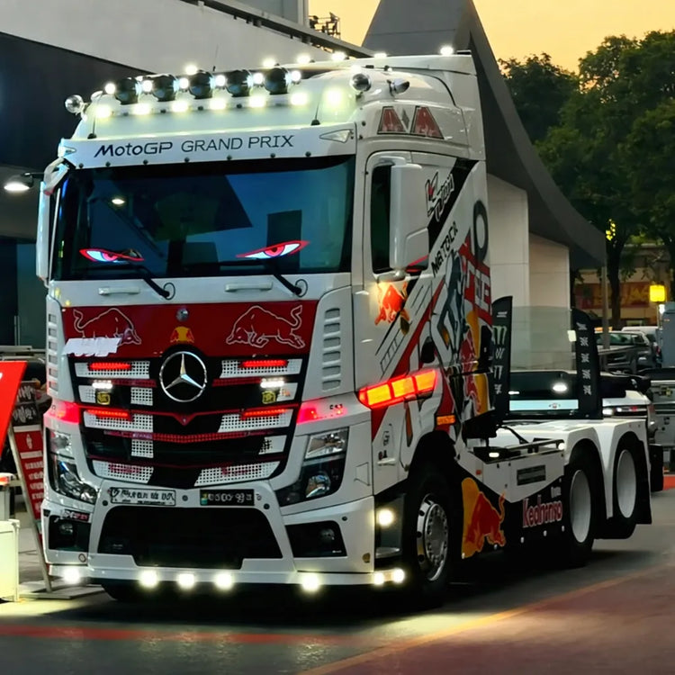 A customized racing semi-truck featuring the Gelrova Demon Eyes 2 Pack Car Window LED Display shining through its front windshield.