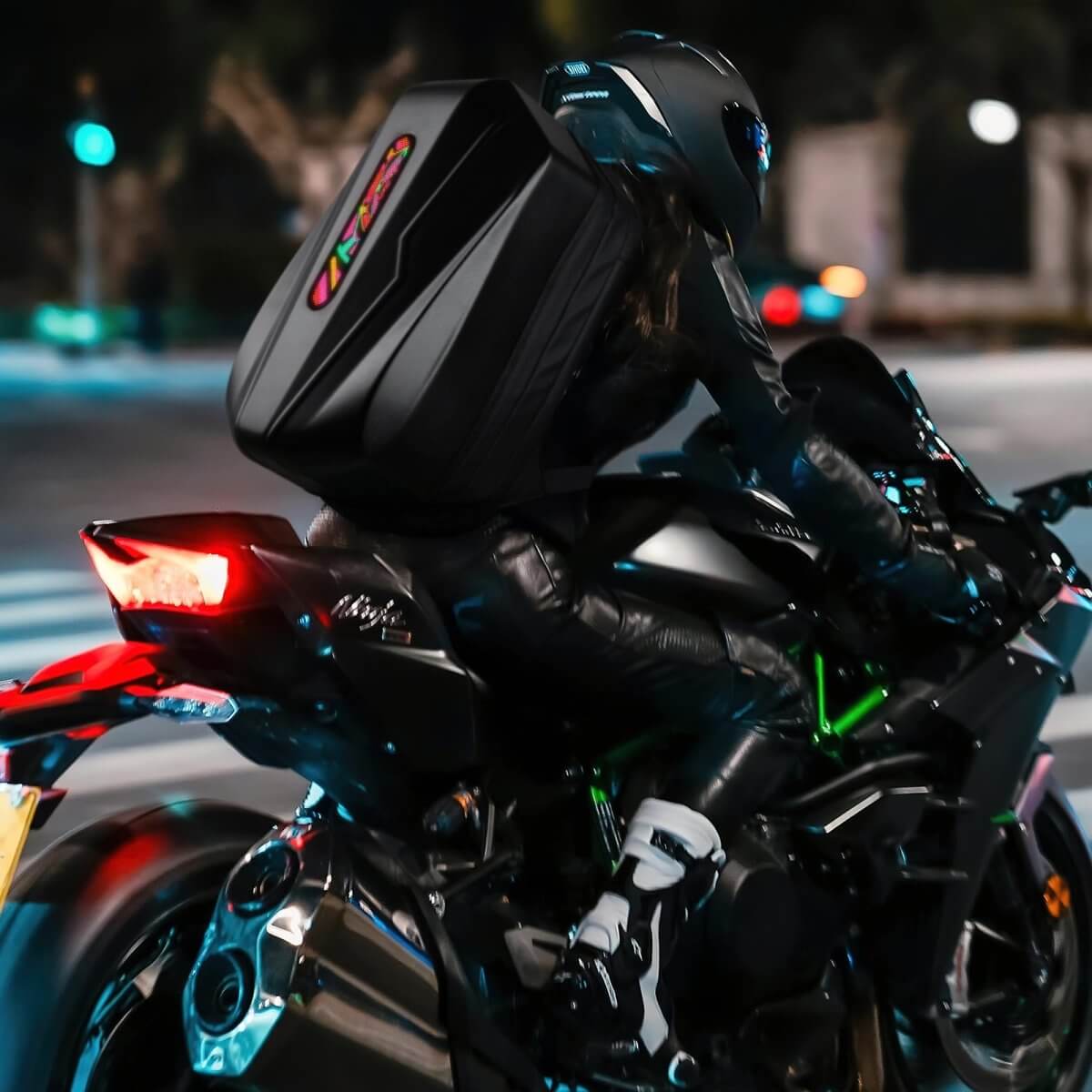 Gelrova LED Motorcycle Backpack - Evolution Series 19" in use by a rider on a motorcycle at night.