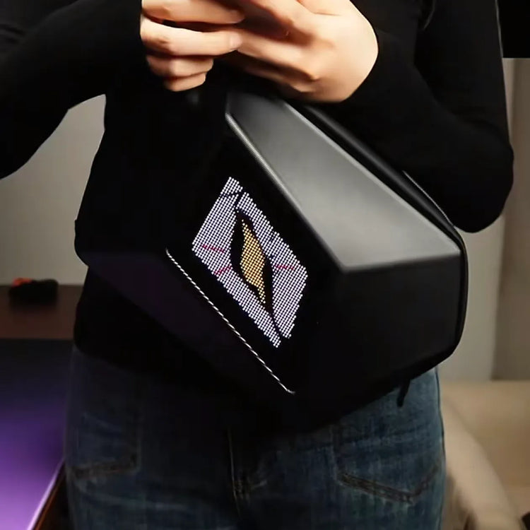 A customer wearing the black Gelrova LED crossbody bag on their chest, featuring a striking single Devil Eye display, while holding a smartphone.